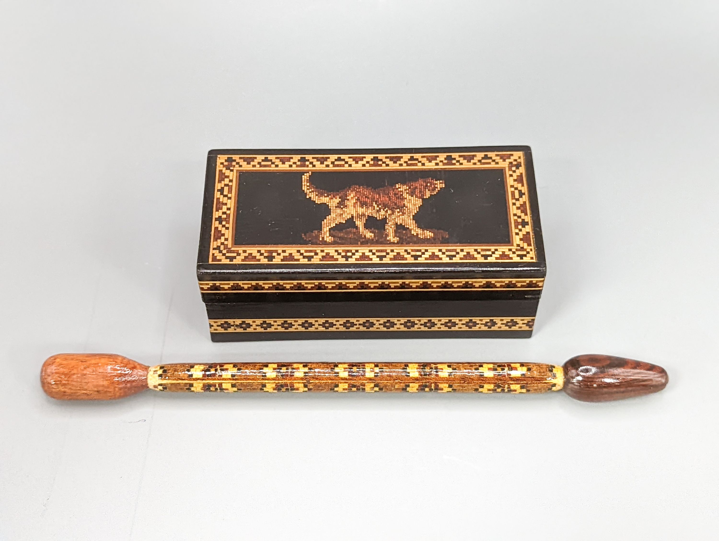 A Victorian Tunbridge ware ebony ground 'dog' ring box, width 9cm, and a stickware glove stretcher